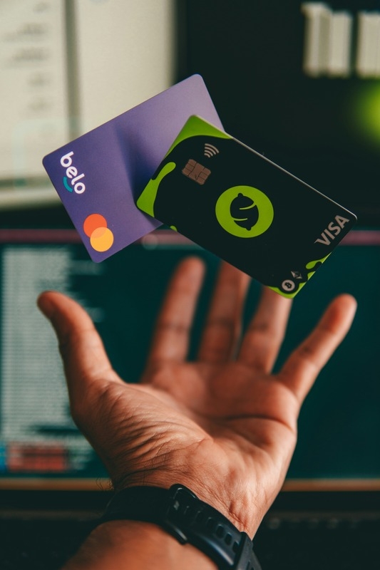 A hand playing with credit cards
